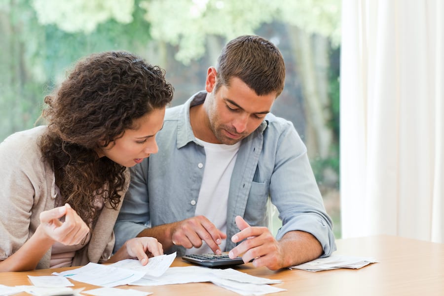 Worried couple paying bills. People fall into difficult financial situations for a variety of reasons, sometimes bankruptcy is the most prudent solution.