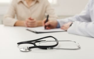 Family member reviewing a loved one's living will with a doctor.