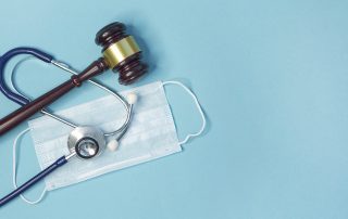 Legal gavel with stethoscope and medical mask, symbolizing personal injury claims during COVID-19.